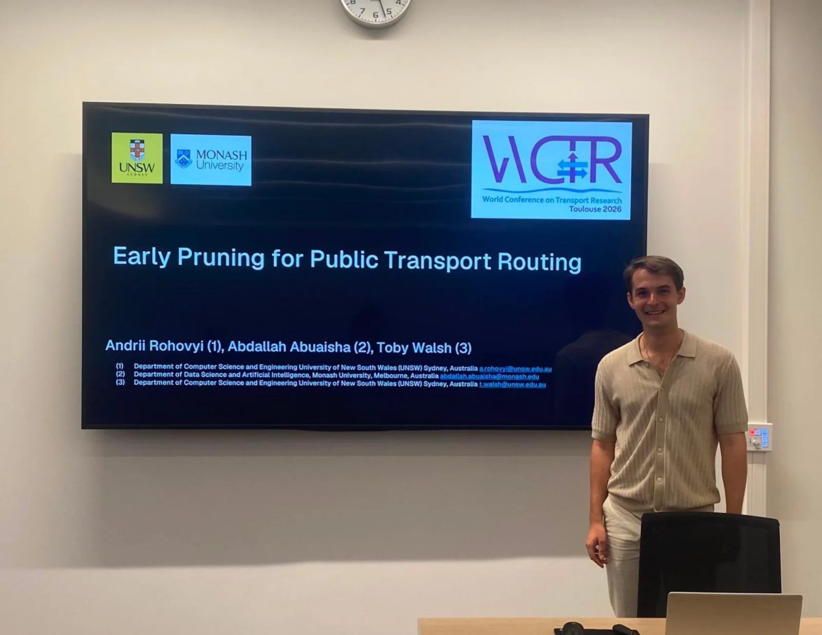 Andrii Rohovyi beside the title slide of Early Pruning for Public Transport Routing at WCTR 2026 in Toulouse